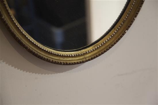 A pair of George III giltwood and gesso oval wall mirrors, W.1ft 5in. H.2ft 7.5in.